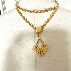 Long gold tone pendant necklace